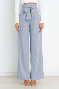 Close-up of light blue high-waisted trousers with matching self-tie bow belt detail