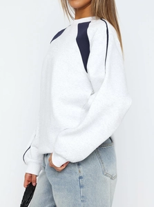 Detail shot of light grey crewneck sweatshirt with navy blue contrast color blocking