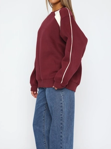 Burgundy crewneck sweatshirt with geometric shoulder panels and loose-fitting design