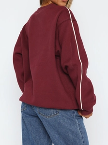Burgundy crewneck sweatshirt with white side stripes and ribbed cuffs for women