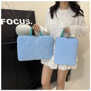 Detailed comparison of two light blue quilted laptop bags in large and small sizes