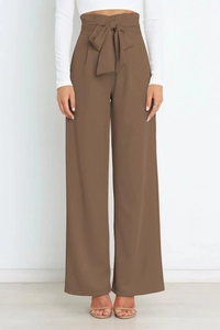 Detail of high waisted coffee brown paper bag trousers with a matching tie-up bow belt