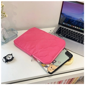 Detail of rose pink heart-quilted iPad sleeve showing smooth metal zipper and soft texture