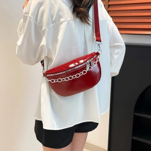 Rote Lackleder-Brusttasche mit silberner Kette am Model in der Seitenansicht