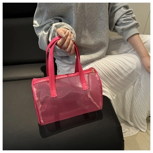 Detail of rose red mesh cylinder handbag with sturdy handles and metal zipper closure
