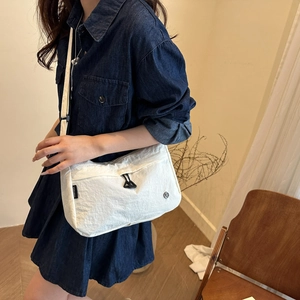 Minimalist white nylon tote bag shown on model for daily casual commute use