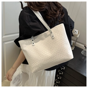 Detail of woven texture and reinforced shoulder strap on large white tote bag