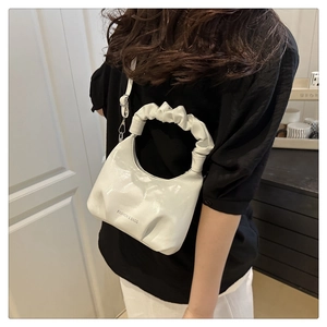 Detail of white pleated cloud handle shoulder bag with Fashion & Bags lettering text