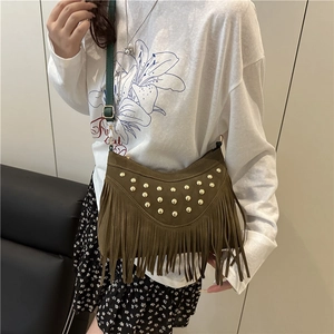 Brown suede crossbody bag with gold studs and long fringe tassels on model