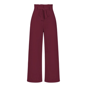 Detail of high waisted wide leg trousers with a stylish paperbag waist and bow belt