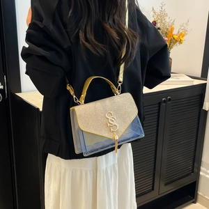 Chic blue quilted handbag with gold glitter flap and tassel shown in lifestyle setting