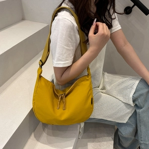 Bright yellow nylon crescent crossbody bag with adjustable wide strap for summer casual wear