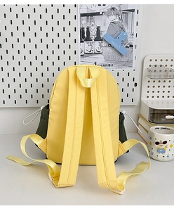 Detail of contrast-colored lightweight backpack with adjustable straps in a lifestyle setting