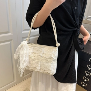Elegant cream lace tote bag featuring multilayered ruffles and matching silk scarf accessory