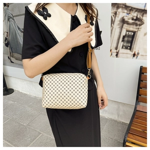 Detail of crossbody tote bag with geometric pattern and brown leather shoulder strap