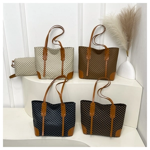 Detail view of large capacity tote bags in four colors with matching pouches on white stand