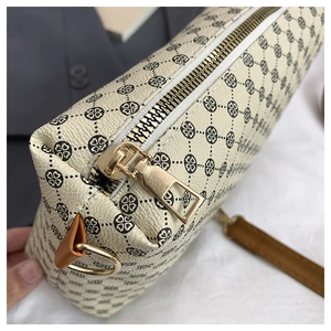 Detailed macro view of large tote bag showing clover pattern and gold zipper detail