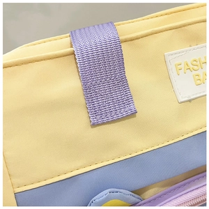 Detail of colorful nylon material with Fashion Bag patch and purple woven loop