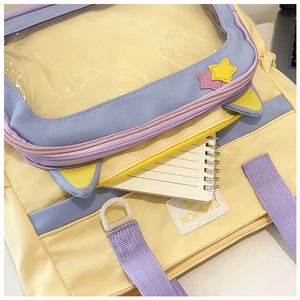 Detail view of large capacity yellow and purple ITA bag showing its clear window and storage