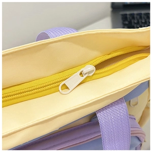 Detail of sturdy zipper closure and woven purple handle on pastel canvas tote bag