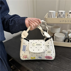 Polka dot crossbody bag with cartoon patches and woven handle in beige and black