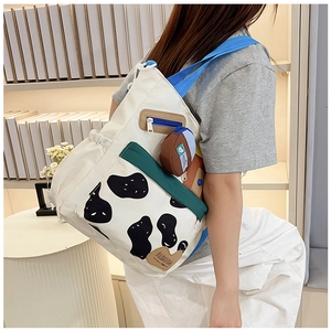 Detail of canvas backpack featuring cow print pocket and fashion leather patch decoration