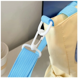 Detail of light yellow canvas bag showing high-strength plastic swivel hook and blue strap