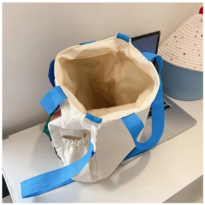 Top view of white canvas tote bag interior with blue strap and inner zipper pocket