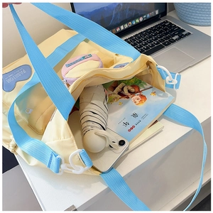 Top view of spacious yellow canvas tote with blue strap showing large storage capacity