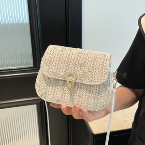 Handwoven crossbody bag in cream white with green floral embroidery and gold metal lock