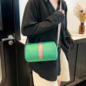 Green barrel crossbody bag with litchi grain leather and a bohemian jacquard wide strap