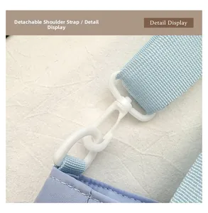 Detail display of light blue detachable shoulder strap with durable white plastic swivel hook