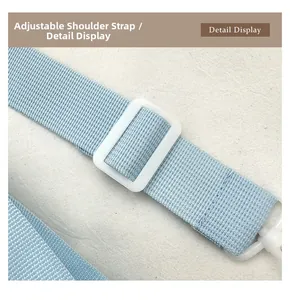 Detail display of the adjustable light blue fabric strap with white buckle and hook