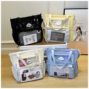 Detail of colorful nylon tote bags featuring transparent pockets and decorative quote cards