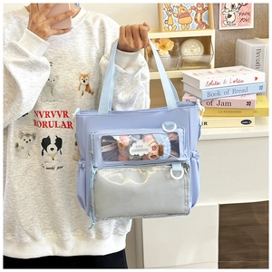 Detail of light blue ita bag showing transparent window and mesh pocket for decor