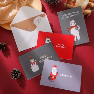 Christmas card set featuring Santa and polar bear with envelopes on a festive background