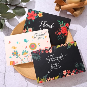 Artistic Thank You card set with floral and bird illustrations on a textured tray