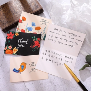 Elegant floral Thank You cards with bird motifs and envelopes on a rustic writing desk
