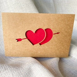 Brown kraft paper thank you card featuring laser-cut heart arrow and red envelope