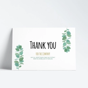 Detail showing a minimalist watercolor eucalyptus thank you card with gold lettering