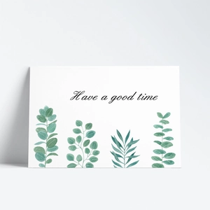 Detail of watercolor green leaves and Have a good time script on white greeting card