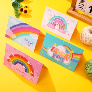 Close-up of assorted rainbow Thank You cards with colorful cloud and star patterns