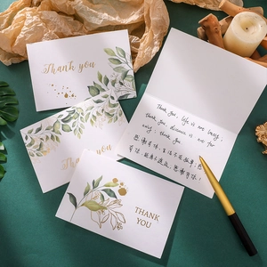 Close-up of Thank You card with gold foil lettering and watercolor floral design