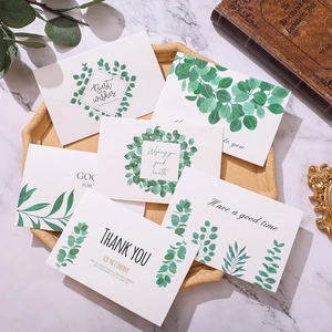 Minimalist botanical greeting cards set with green leaves and thank you text on a tray