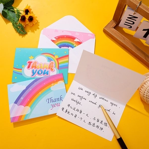 Rainbow themed foldable thank you cards set with white envelopes on yellow background