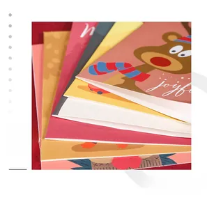 Gros plan de cartes de Noël empilées avec motifs de rennes sur fond de velours rouge