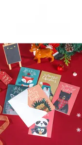 Close-up of festive Christmas cards with cute animal illustrations and white envelopes