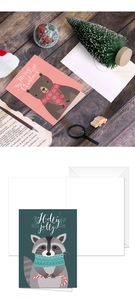 Detailed view of Christmas cards featuring cute bear and raccoon with white envelopes