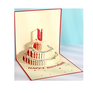 3D pop-up birthday card with a three-layer paper cake and a candle on blue background