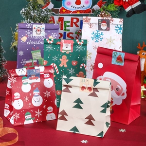 Set of 24 Christmas kraft paper gift bags with festive snowman and Santa patterns